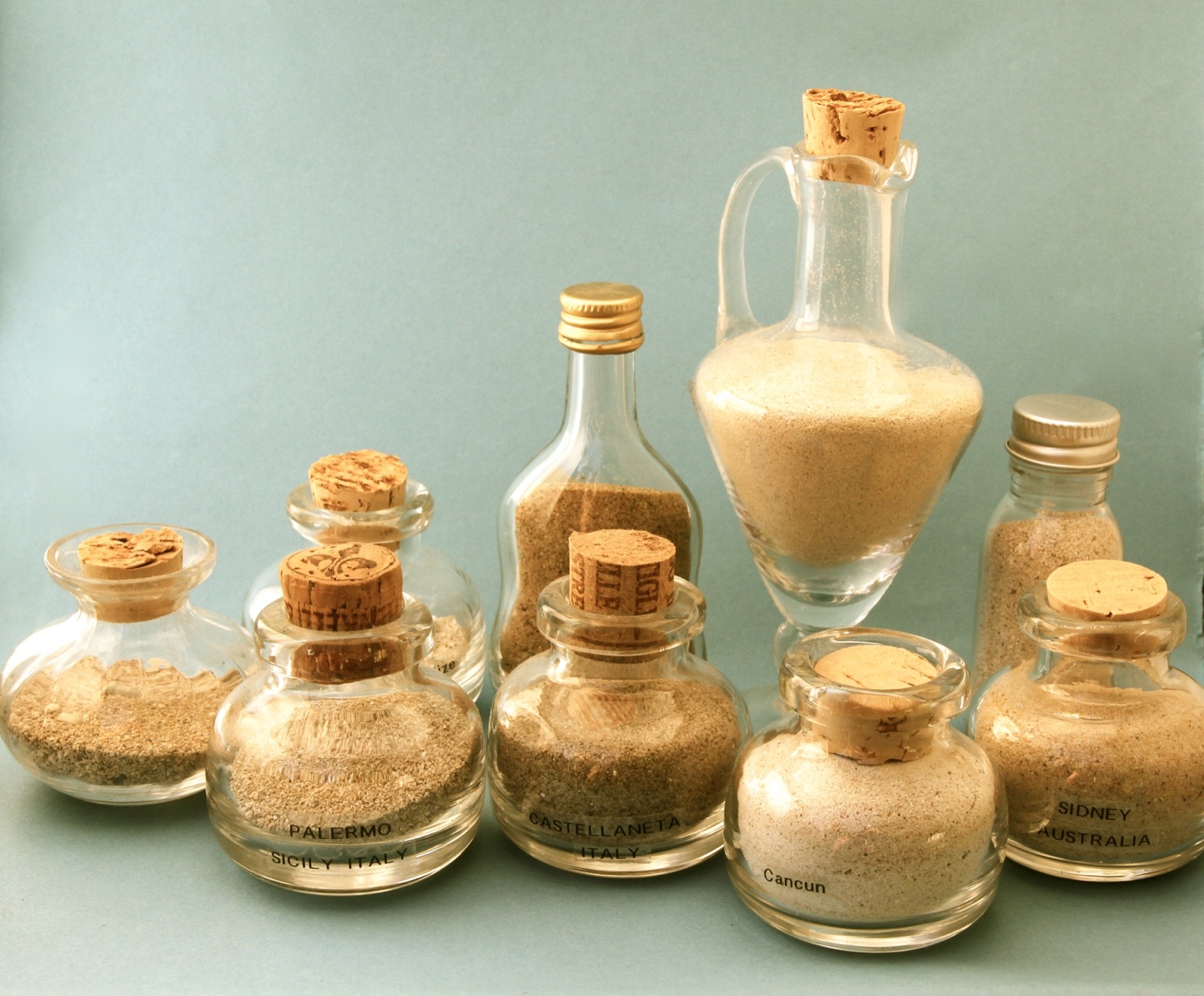 Small corked glass jars and bottles filled with sand of different colours